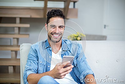 Smiling smart man using smartphone Stock Photo