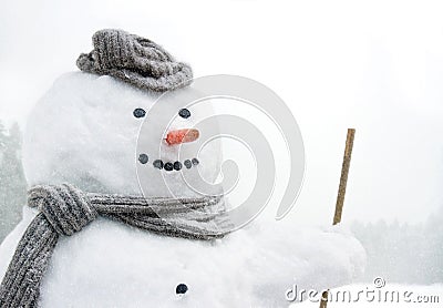 Smiling snowman outdoors in snowfall Stock Photo