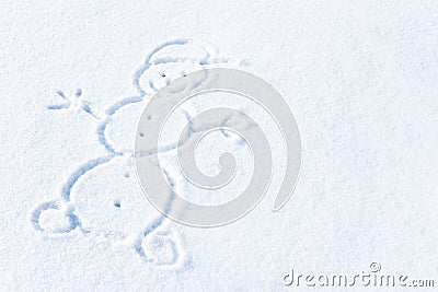 Smiling snowman painted on fresh snow on a sunny day Stock Photo