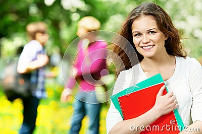 Smiling student girl outdoors with workbooks Stock Photo