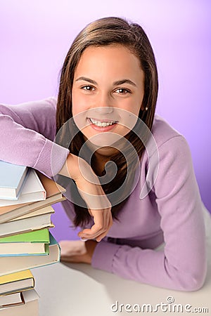 Smiling student girl with pile of books Stock Photo