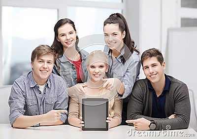 Smiling students with blank tablet pc screen Stock Photo