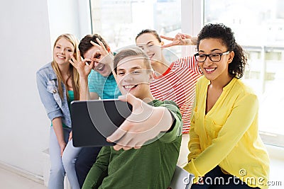 Smiling students making picture with tablet pc Stock Photo