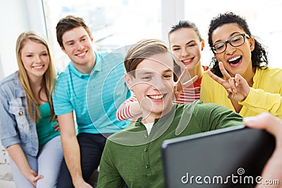 Smiling students making selfie with tablet pc Stock Photo