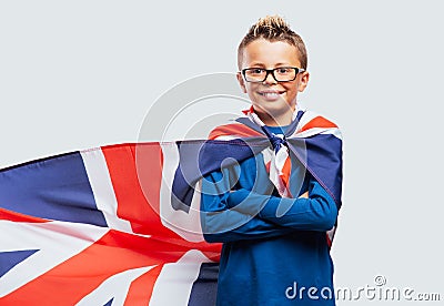 Smiling superhero boy with British flag cape Stock Photo