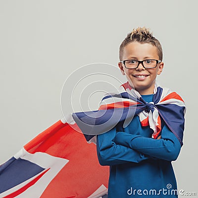 Smiling superhero boy with British flag cape Stock Photo