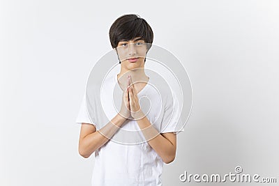 Smiling teen boy greeting with palms gesture pressed together Stock Photo