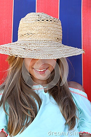 Smiling teen girl in hat on beach Stock Photo