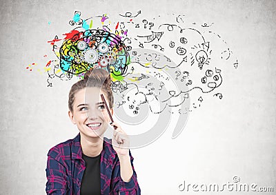 Smiling teen girl thinking, pencil, cog brain Stock Photo