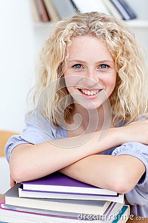 Smiling teen studying a lot of books Stock Photo