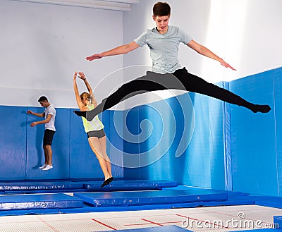 Teenage boy jumping on trampoline Stock Photo