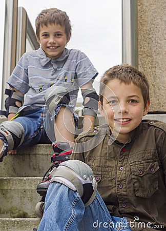 Smiling teenage boys in roller-blading protection kits Stock Photo