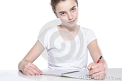 Smiling teenage girl with copy book and pencil Stock Photo