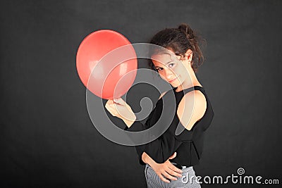 Smiling teenage schoolgirl with red baloon Stock Photo