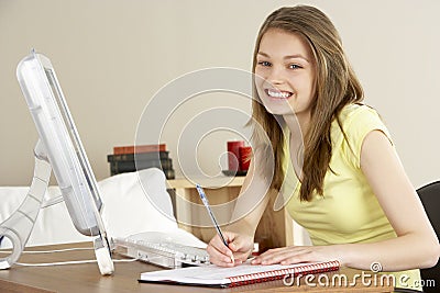 Smiling Teenage Girl Studying at Home Stock Photo