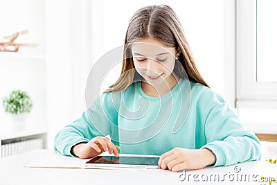 Smiling teenage girl with tablet Stock Photo