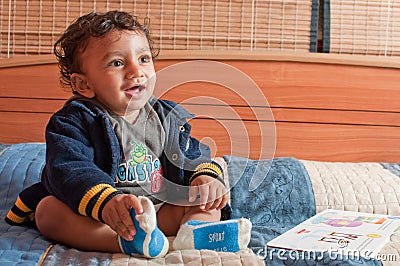 Smiling toddler having fun with a book Stock Photo