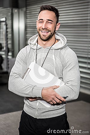 Smiling trainer holding clipboard Stock Photo