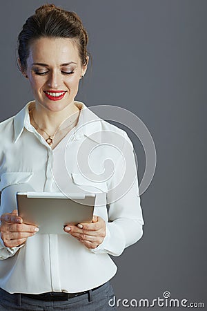 smiling trendy business woman against gray background Stock Photo