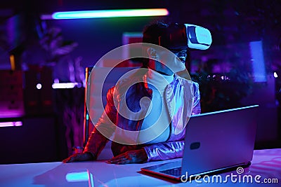 smiling trendy business woman in vr headset in modern office Stock Photo