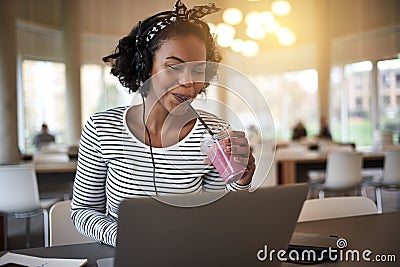 Smiling university student studying and drinking a smoothie on c Stock Photo