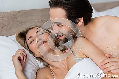 smiling unshaven man waking happy blonde Stock Photo