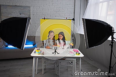 smiling video bloggers showing spiral toy Stock Photo