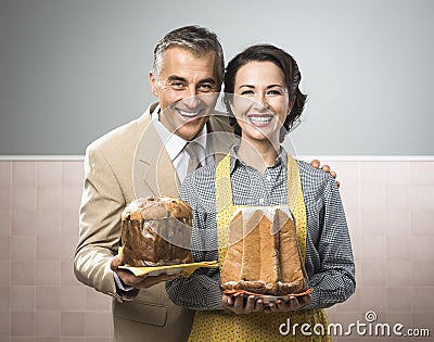 Smiling vintage couple with cakes Stock Photo