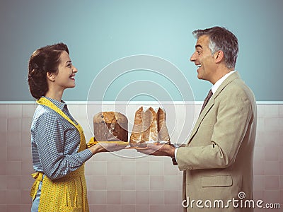 Smiling vintage couple with cakes Stock Photo