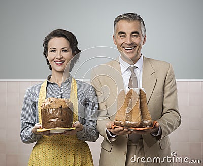 Smiling vintage couple with cakes Stock Photo