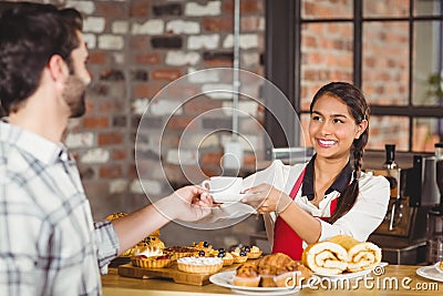 Smiling waitress serving a client Stock Photo