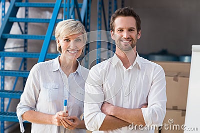Smiling warehouse managers looking at camera Stock Photo