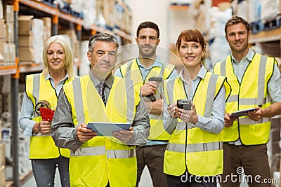 Smiling warehouse team looking at camera Stock Photo