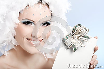 Smiling winter beauty with christmas present Stock Photo
