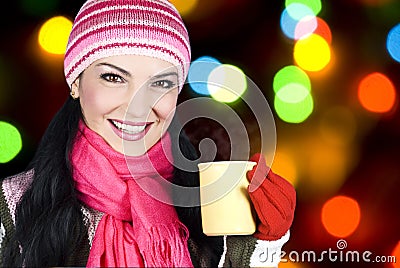 Smiling winter woman holding hot tea Stock Photo