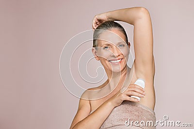 Mature woman using deodorant stick Stock Photo