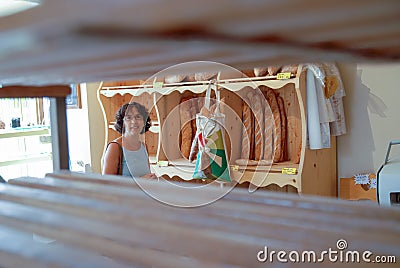 Smiling woman in bakery shop Stock Photo