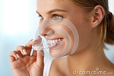 Smiling Woman With Beautiful Smile Using Invisible Teeth Trainer Stock Photo