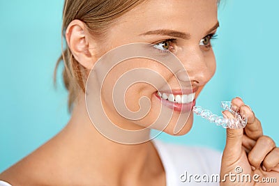 Smiling Woman With Beautiful Smile Using Invisible Teeth Trainer Stock Photo