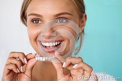 Smiling Woman With Beautiful Smile Using Teeth Whitening Tray Stock Photo