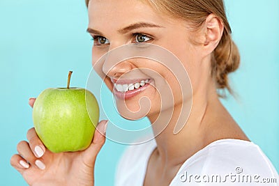 Smiling Woman With Beautiful Smile, White Teeth Holding Apple Stock Photo