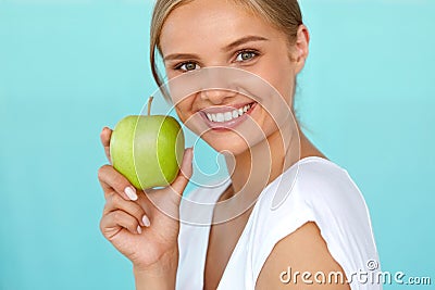 Smiling Woman With Beautiful Smile, White Teeth Holding Apple Stock Photo
