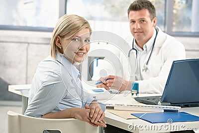 Smiling woman in doctor's office Stock Photo