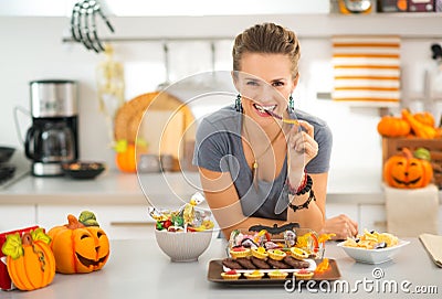 Smiling woman eating trick or treat halloween candy Stock Photo