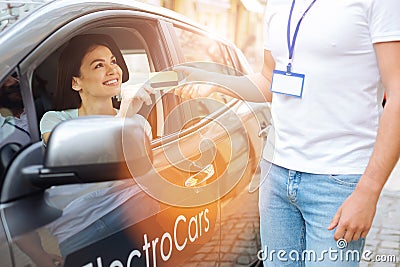 Smiling woman handing a credit card to the employee Stock Photo