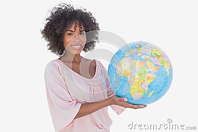 Smiling woman holding globe Stock Photo