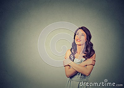 Smiling woman holding hugging herself dreaming contemplating Stock Photo