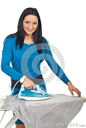 Smiling woman ironing a shirt Stock Photo