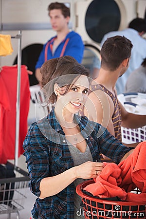 Smiling Woman in Laundromat Stock Photo