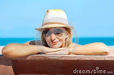 A smiling woman looking at the camera on the sea background Stock Photo